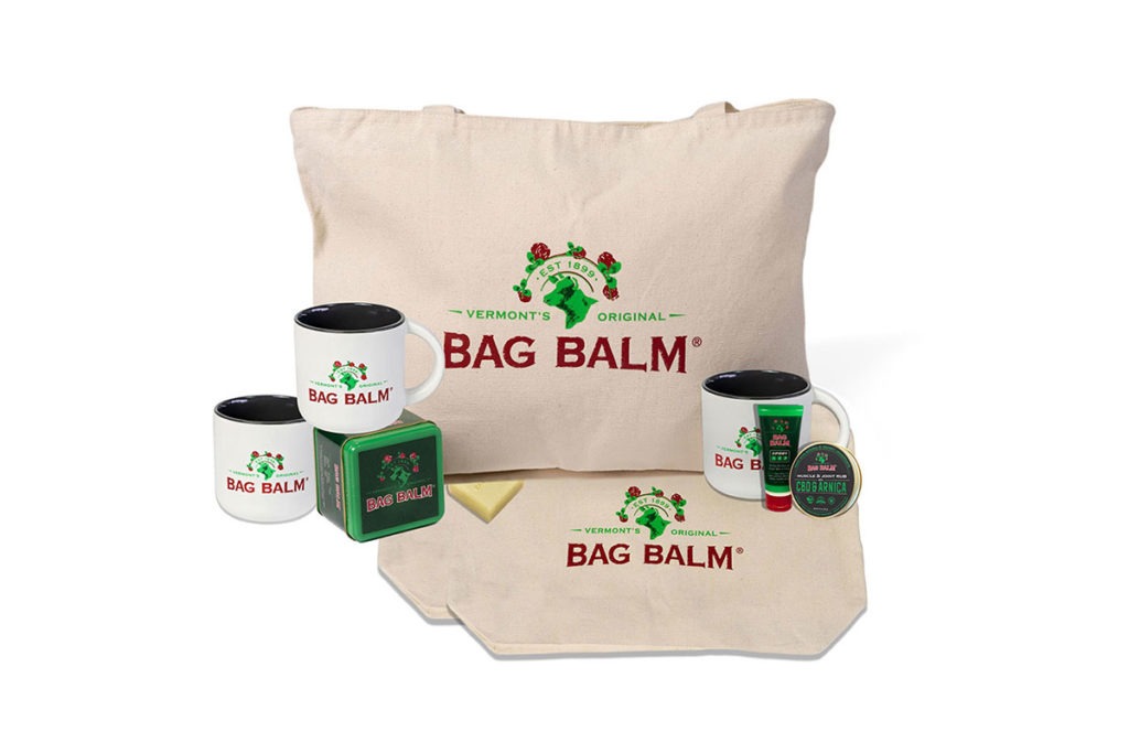 Product Shots of the Bag Balm Collection, including Bag Balm branded tote bag, coffee mugs, and other swag