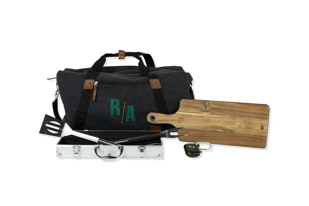 Product Shot of a R/A Cooking Set, Complete with a Wooden Cutting Board, Grilling Utensils, and a Duffle Bag