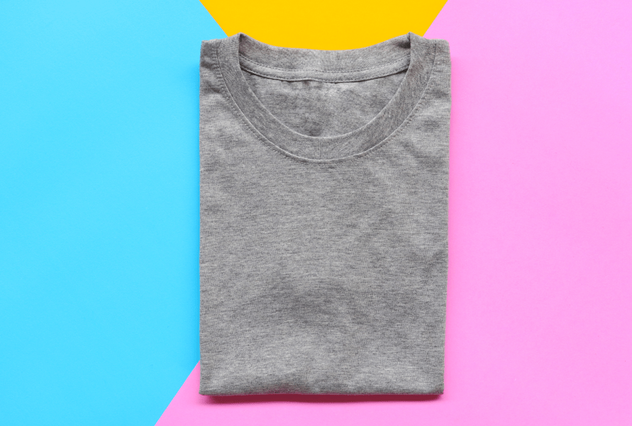 Gray crew neck tee shirt on a yellow, blue, and pink background