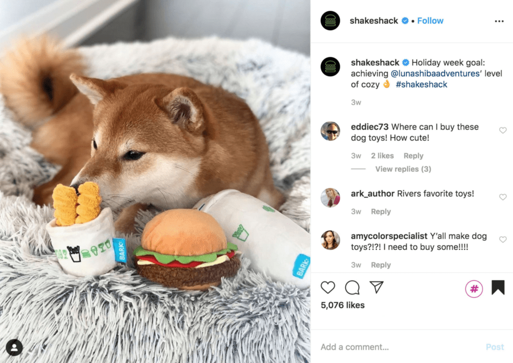 Shake Shack dog toys in a dog bed with a golden dog